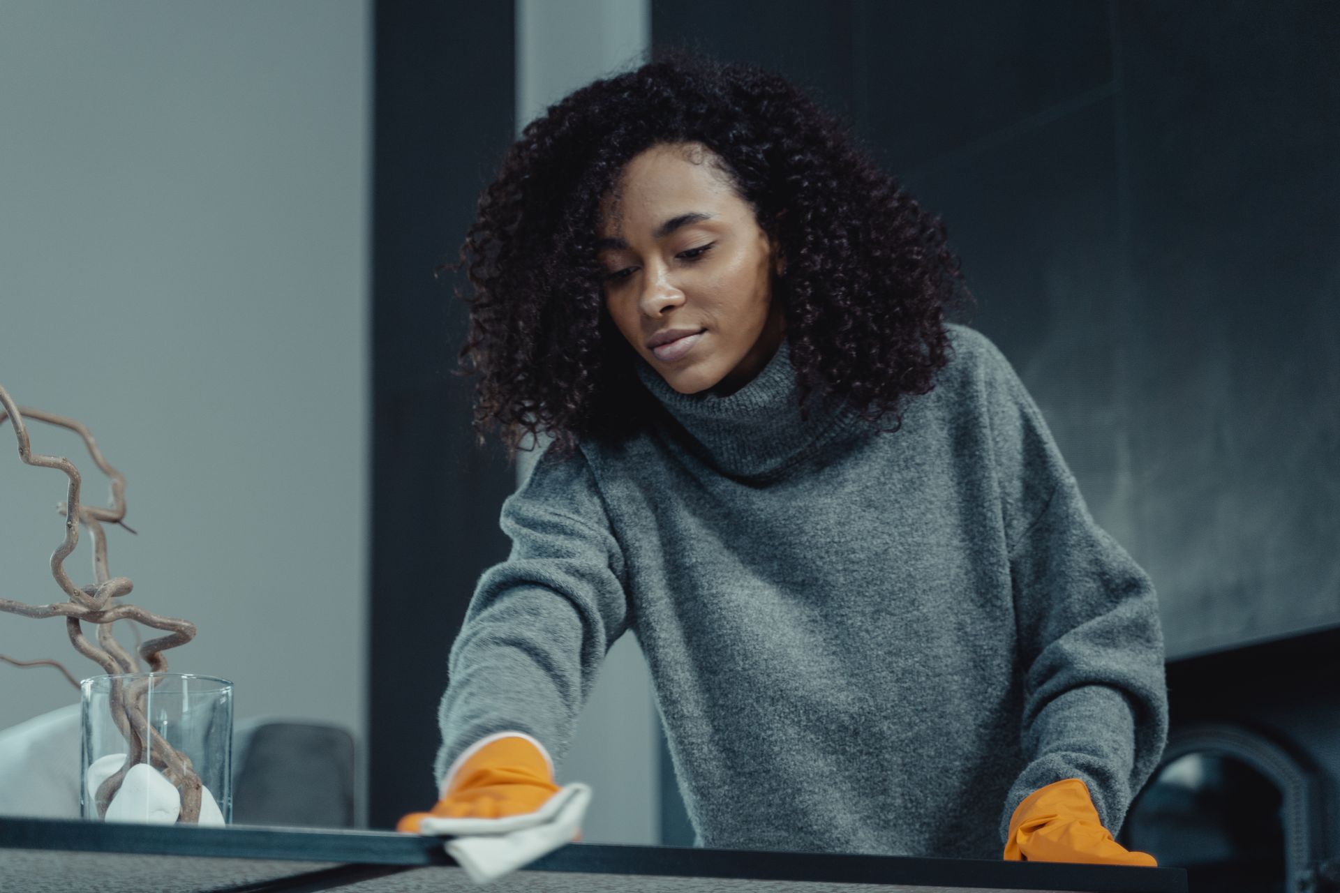 Residential cleaner wiping a surface in a modern home